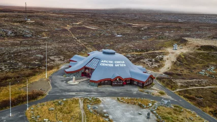 Zelfklevend Fotobehang Arctic Circle Center stands amidst the barren tundra on a rocky meadow © Daniel