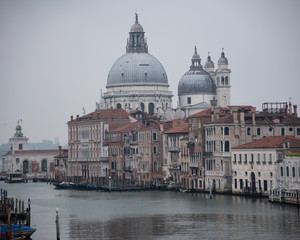 Grand Canal and the island of Santa Maria della Salute with the Dogana from the Accademia bridge in Venice, Italy. Widespread dawn light on the lagoon.