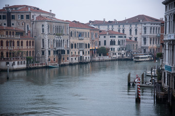 Fototapeta na wymiar Grand Canal from the Accademia bridge in Venice, Italy. Dawn light spread over the lagoon with a view of the old houses and the ferry. Widespread dawn light on the Venetian lagoon.