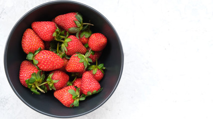 Sweet summer strawberry on white stone table. Copy space. Fresh berries, summer dessert. 16:9