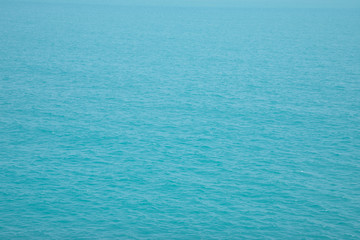 Blue Sea surface aerial view with waves from a drone, empty blank to background. soft focus.