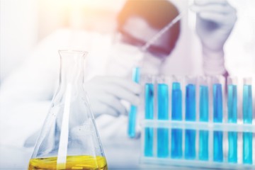 Hand holding syringe and vaccine.