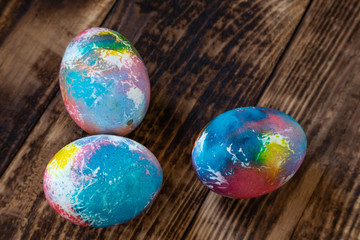 Colorful Easter eggs with an abstract pattern on the shell are on a wooden background