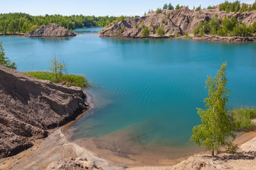Fototapeta na wymiar Aerial view of amazing Blue lakes near village Konduki, Tula region, Russia. In the past the abandoned quarry turned into picturesque lakes and hills covered with the wood.