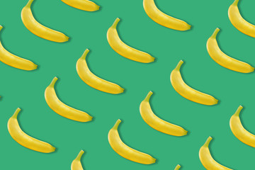 colourful fruit pattern of fresh yellow bananas on colored background