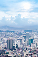 Seoul cityscapes, skyline, high rise office buildings and skyscrapers in Seoul city, winter daylight, top view in winter, Seoul, Republic of Korea, in mist winter season with blue sky and cloud