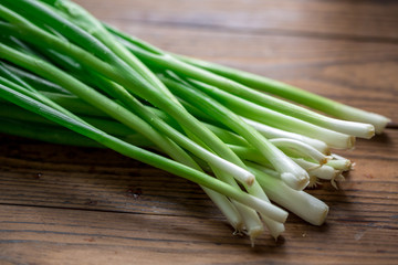 Fresh green shallot on wood background
