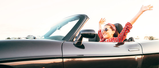 Young cheerful smiling female driving convertible car at sunny day time headers web site - obrazy, fototapety, plakaty
