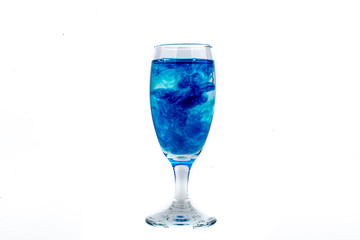 Blue food coloring diffuse in water inside wine glass with empty copyspace area for slogan or advertising text message, over isolated white background.
