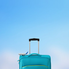 holidays. travel concept. blue suitcase and airplane toy infront of bokeh blue background