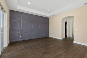 Master Bedroom with custom wood work on wall.