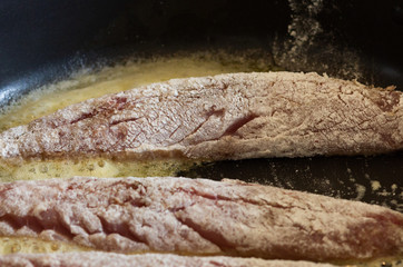 Several fillet mackerels fried on pan