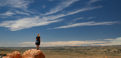 silhouette of a woman on top of the mountain