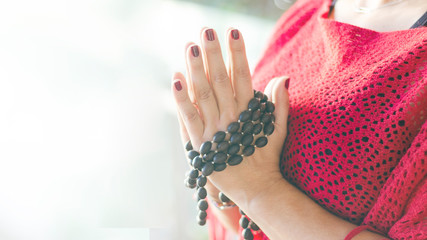 Female hands with mala beads in namaste. Meditation and yoga practice yoga concept for background....