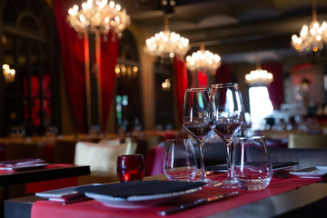Fototapeta na wymiar Empty wine glasses stand on table in restaurant