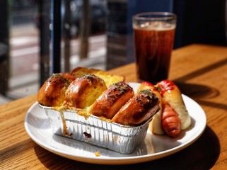 butter milk bread with sausage and iced black coffee