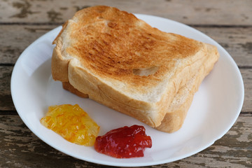 roasted bread with orange and strawberry jam