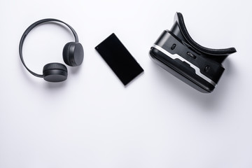 The view from the top device of the gamer generation z, earphone, smartphone, VR glasses with copy space