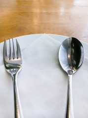 White plate with the silver spoon and fork.