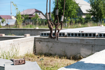 A crane raised a concrete slab at a construction site at home