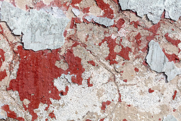 Concrete wall with cracked paint as abstract background
