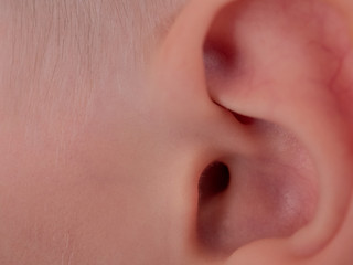 Naklejka premium Beautiful ear of ten year old child close up, 10 y.o. kid