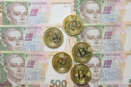 Bitcoins on Ukrainian currency (hryvnia) banknotes.