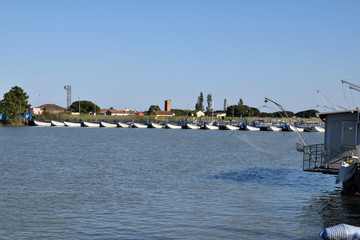 Fototapeta na wymiar The long bridge of boats on the Po river - Italy