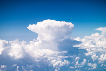 Naklejka na ściany i meble Beautiful giant Cumulonimbus, dense, towering vertical cloud forming from water vapor carried by powerful upward air currents from the airplane