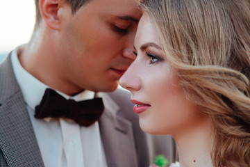 Happy newlywed couple. Beautiful bride and groom in a suit.
