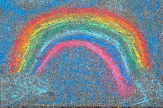 Very colorful child&rsquo;s Sidewalk chalk rainbow. Wrong sequence but artistically beautiful 