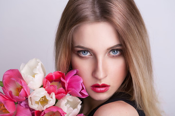 blonde face,  blue eyes, tulips flowers