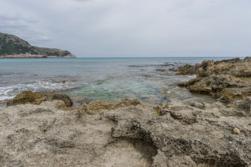 Mediterranean sea crashing against the rocks of the Spanish island of Mallorca, Ibiza, Spain.