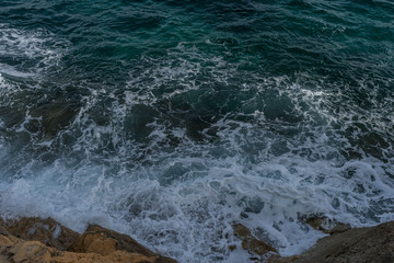Mediterranean sea crashing against the rocks of the Spanish island of Mallorca, Ibiza, Spain.