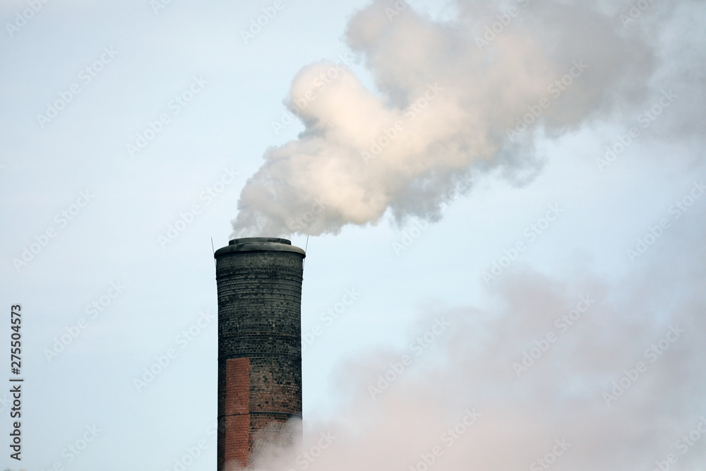 Wall mural smoke billows from a tall chimney