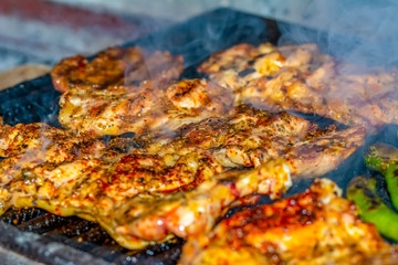 Obraz na płótnie Canvas Tasty chicken meat on the grill with fire flames