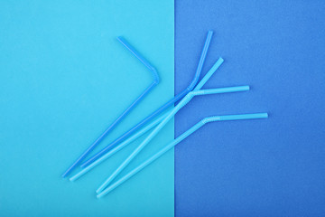 Drinking straws on blue background. Summer cocktail party, fun and happy vacation concept.