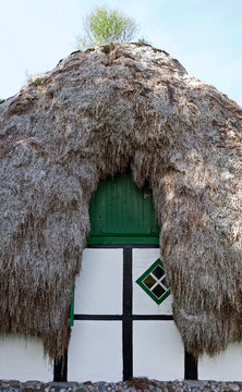 Laesoe / Denmark: Front side of an old half-timbered cottage with seaweed roof
