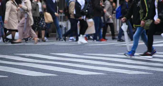 Legs of walking people at the crossing rainy day. Shibuya district Tokyo Japan - 04.30.2019 : It is a center of the city in tokyo. camera : Canon EOS 5D mark4