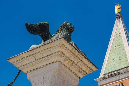Sculpture depicting image of lion with wings, symbol of Venice, on the top of the column at San Marco, Italy