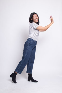 Full body of beautiful young asian woman push something.