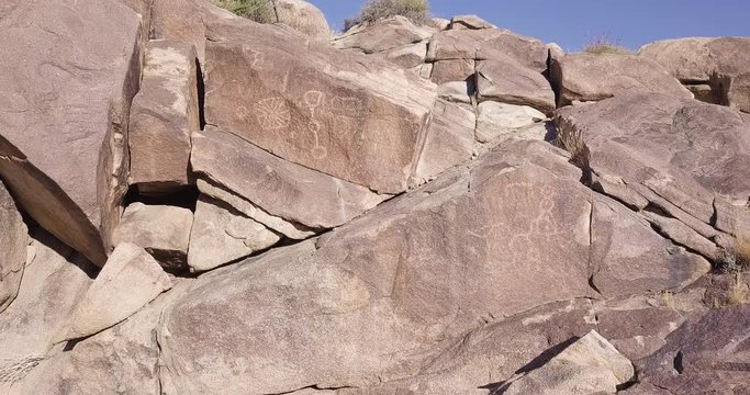 boulder with Native American Petroglyphs, Coyote Hole Canyon, Joshua tree, yucca valley,california, mojave desert, aerial drone orbiting shot