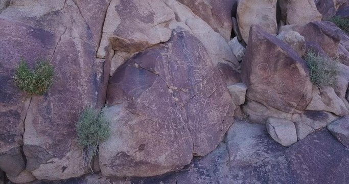 aerial drone orbiting shot of boulder with Native American Petroglyphs, Coyote Hole Canyon, Joshua tree, yucca valley,california, mojave desert