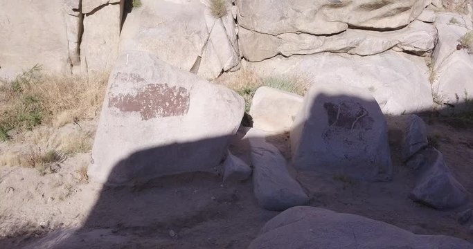 aerial drone orbiting sjot around boulders in the shadow with Petroglyphs,Coyote Hole Spring Canyon , Joshua tree, Yucca Valley, California