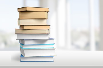 Colorful books collection on background.