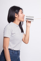 Young Asian woman with tin can phone.