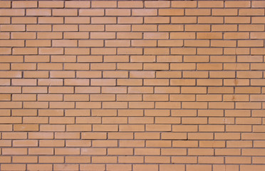 Classic brick wall made of light brown brick. Modern smooth brickwork.