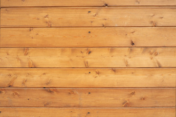 The background and texture of the walls of wood veneer covered wood..