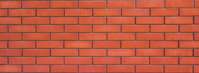 Classic brick wall made of red brick. Modern smooth brickwork.