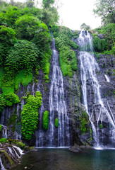 Banyumala waterfall  with cascades among the green tropical trees and plants in the North of the island of Bali, Indonesia